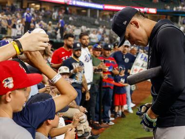 New York Yankees right fielder Aaron Judge (99) signs autographs during batting practice...