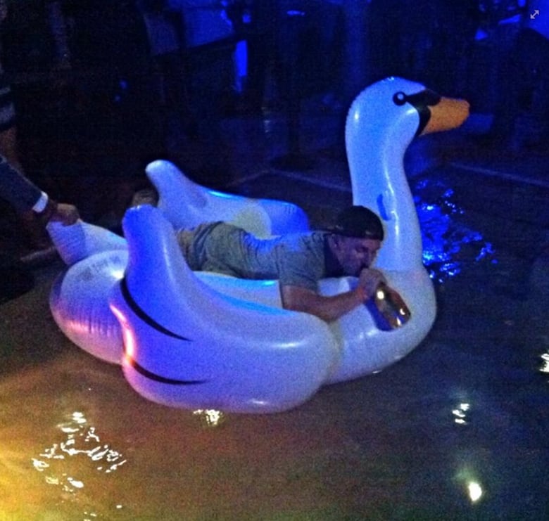 Here's Johnny Manziel riding an inflatable swan and drinking Ace of Spades in June 2014.