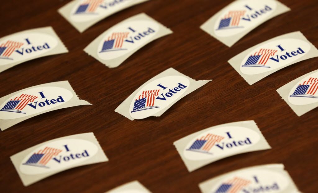 I Voted stickers sit on a table during early voting for the Nov. 6th election, Wednesday,...