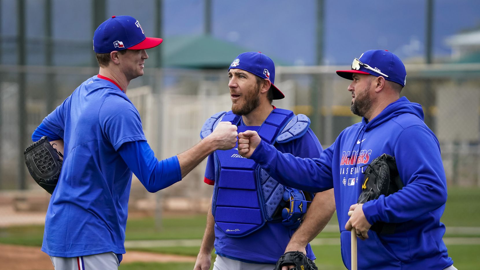 Texas Rangers pitcher Kyle Gibson (left) fist bumps Frisco manager Bobby Wilson after throw...