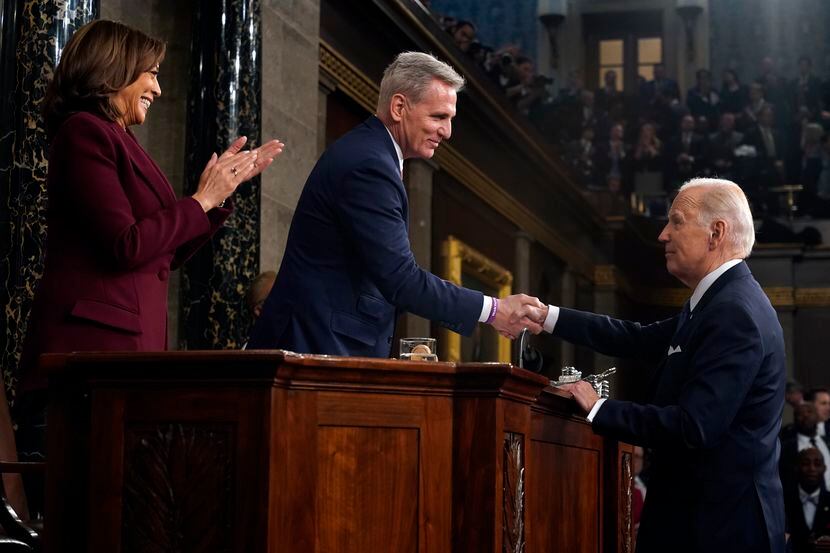 President Joe Biden shakes hands with House Speaker Kevin McCarthy of Calif., as Vice...