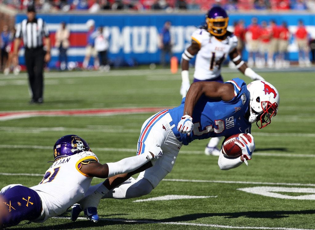 DALLAS, TEXAS - NOVEMBER 09:  James Proche #3 of the Southern Methodist Mustangs is tackled...