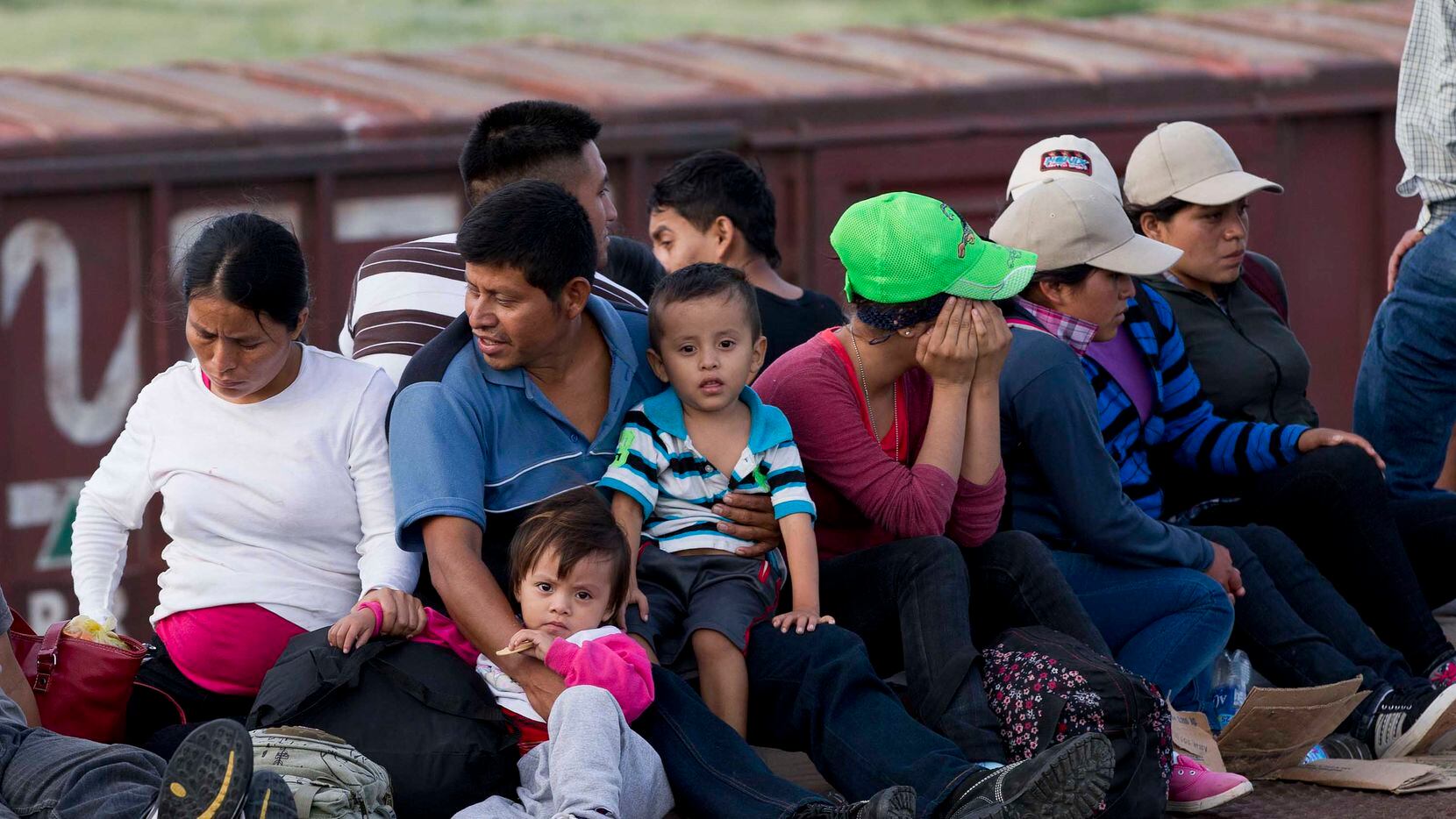 Central American migrants ride a freight train during their journey toward the U.S.-Mexico...