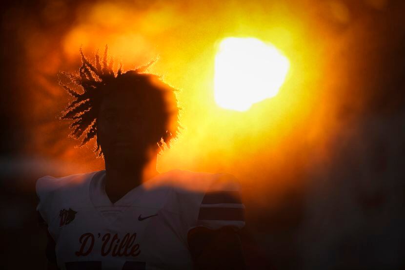 The sun sets behind Jerry Scales, a Duncanville High School offensive lineman, as he is...
