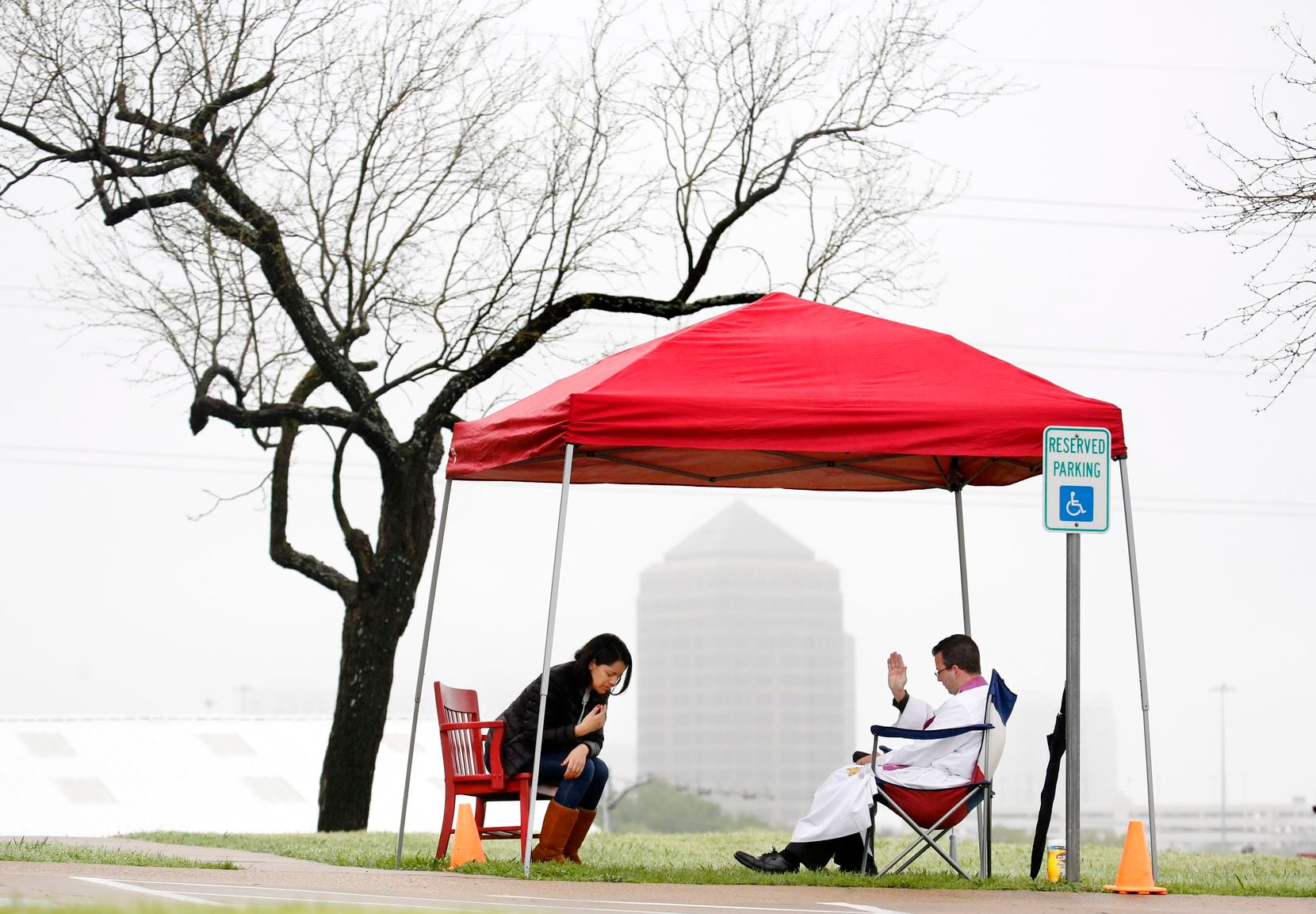 Regnum Christi priest Michael Picard prayed with Anabel Cardova of Coppell during an outdoor...