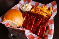 Barbecue boxes at Ribbee's in Fort Worth include one type of ribs (here, hot honey) with a...