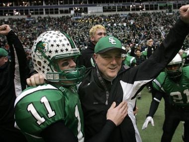 Southlake Carroll head coach Todd Dodge (right) and his sophmore son Riley Dodge (11) celebrate their 5A Division II Championship win over Katy at Texas Stadium , Saturday, December 16, 2005.