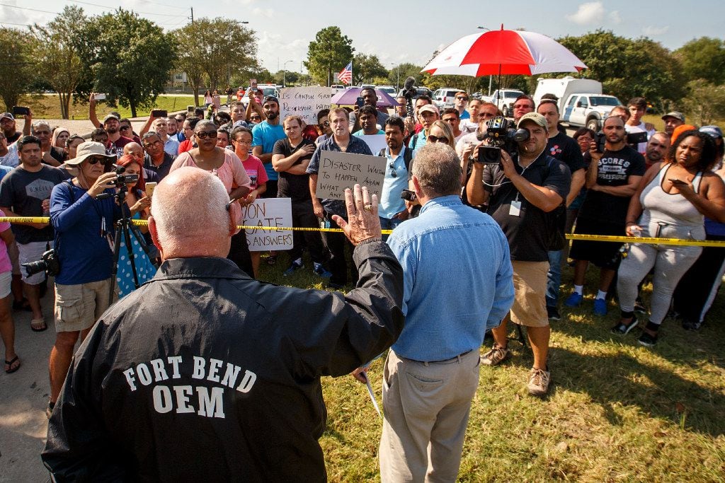 Fort Bend County Judge Robert Hebert raises his hand as he takes questions from Cinco Ranch...
