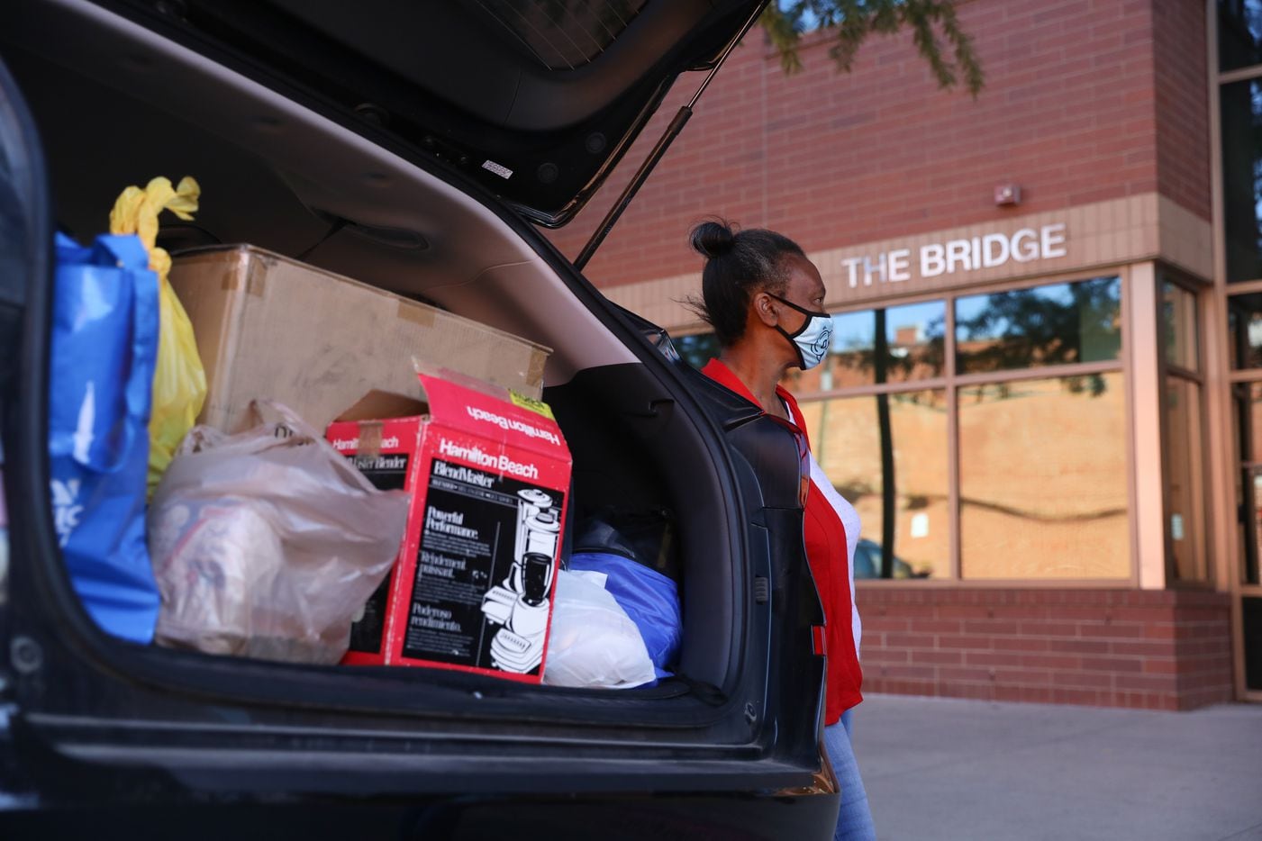 Patricia Freeman by a car filled with her belongings outside of The Bridge Homeless Recovery Center on November 19, 2021, waiting to depart for her new apartment. Freeman got help getting her new home through the Dallas Rapid Rehousing program. (Liesbeth Powers/Special Contributor)