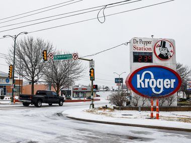 People drive on a snowy E Mockingbird Ln and Greenville in Dallas on Thursday, February 3,...