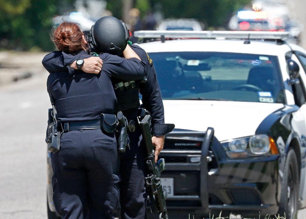 Two Dallas Police Officers comfort each other on the active shooting scene where a Dallas...