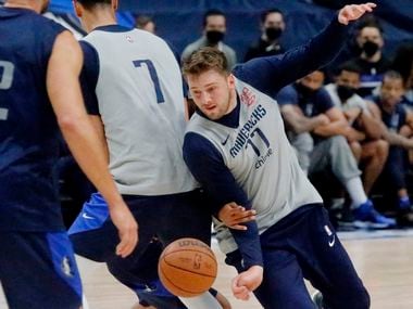Dallas Mavericks guard Luka Doncic (77) slips behind a screen from Dallas Mavericks center Dwight Powell (7) as the Dallas Mavericks held their Mavs Fam Jam, a scrimmage free to the public at the American Airlines Center in Dallas on Sunday, October 3, 2021.