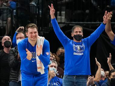 Dallas Mavericks guard Luka Doncic and owner Mark Cuban celebrate a 3-pointer during the...
