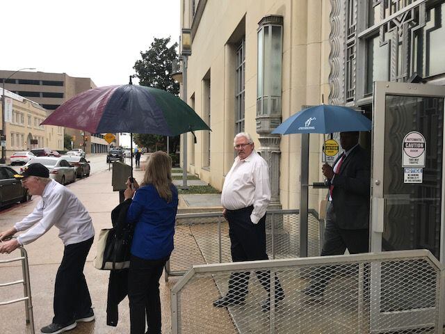 Glenn Halfin (center) leaves the federal courthouse in Fort Worth after being sentenced to a...