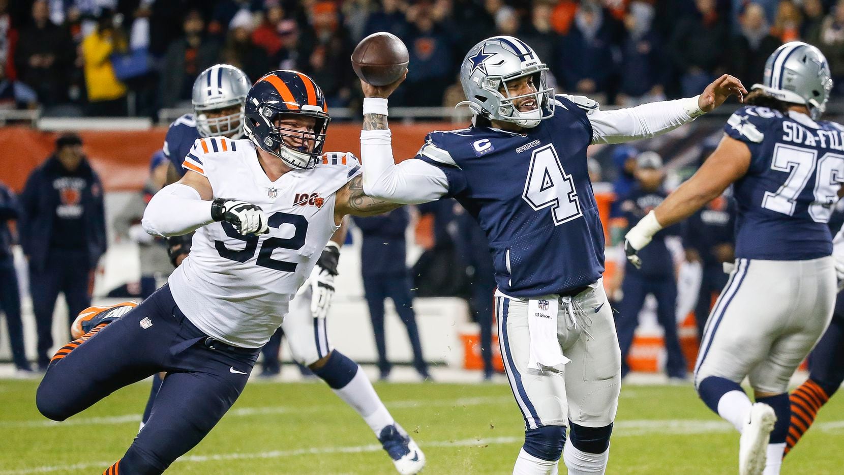 Dallas Cowboys quarterback Dak Prescott (4) fires off a pass before being brought down by Chicago Bears defensive end Brent Urban (92) during the second half a NFL matchup between the Dallas Cowboys and the Chicago Bears on Thursday, Dec. 5, 2019, at Soldier Field in Chicago.