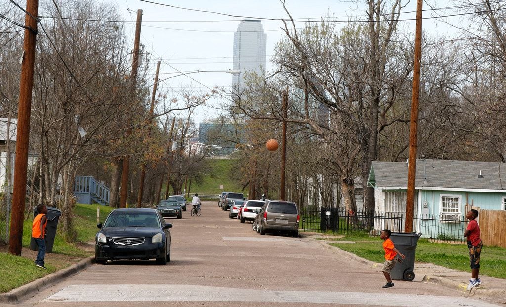 Kids play basketball in the Dallas Bottom District in southeast Dallas in a, 2018. file photo.