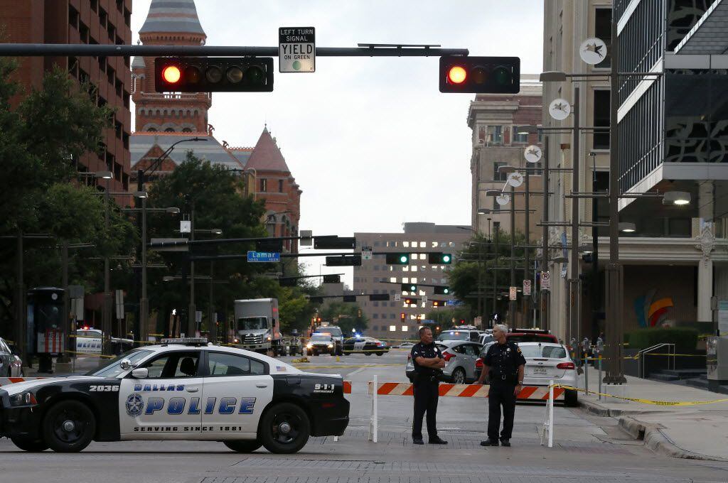 Dallas Police Department officers block Main Street near the El Centro College building in...