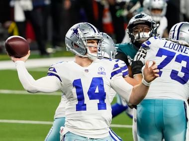 Dallas Cowboys quarterback Andy Dalton (14) gets a block from center Joe Looney (73) as he throws a pass during the third quarter of an NFL football game against the Philadelphia Eagles at AT&T Stadium on Sunday, Dec. 27, 2020, in Arlington.