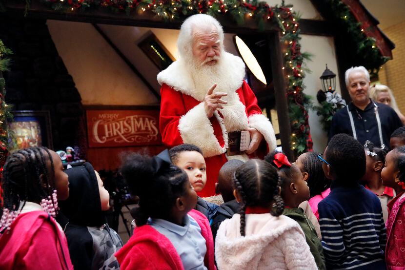 Santa Claus gives a lesson to kids from Beltline Elementary in Lancaster, Texas as they...
