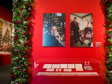 Photos of George W. Bush greeting members of the military are displayed at a Christmas...