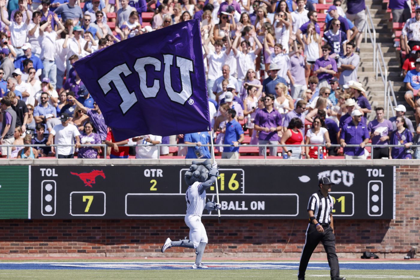 TCU mascot SuperFrog runs with a flag after a touchdown during the first half of a game...