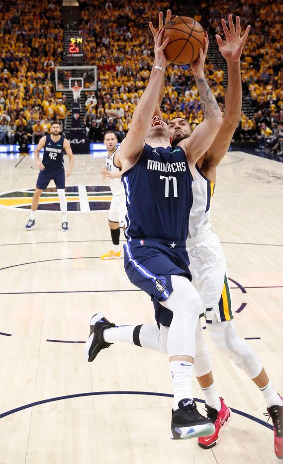 Dallas Mavericks guard Luka Doncic (77) is fouled by Utah Jazz center Rudy Gobert (27) on a...