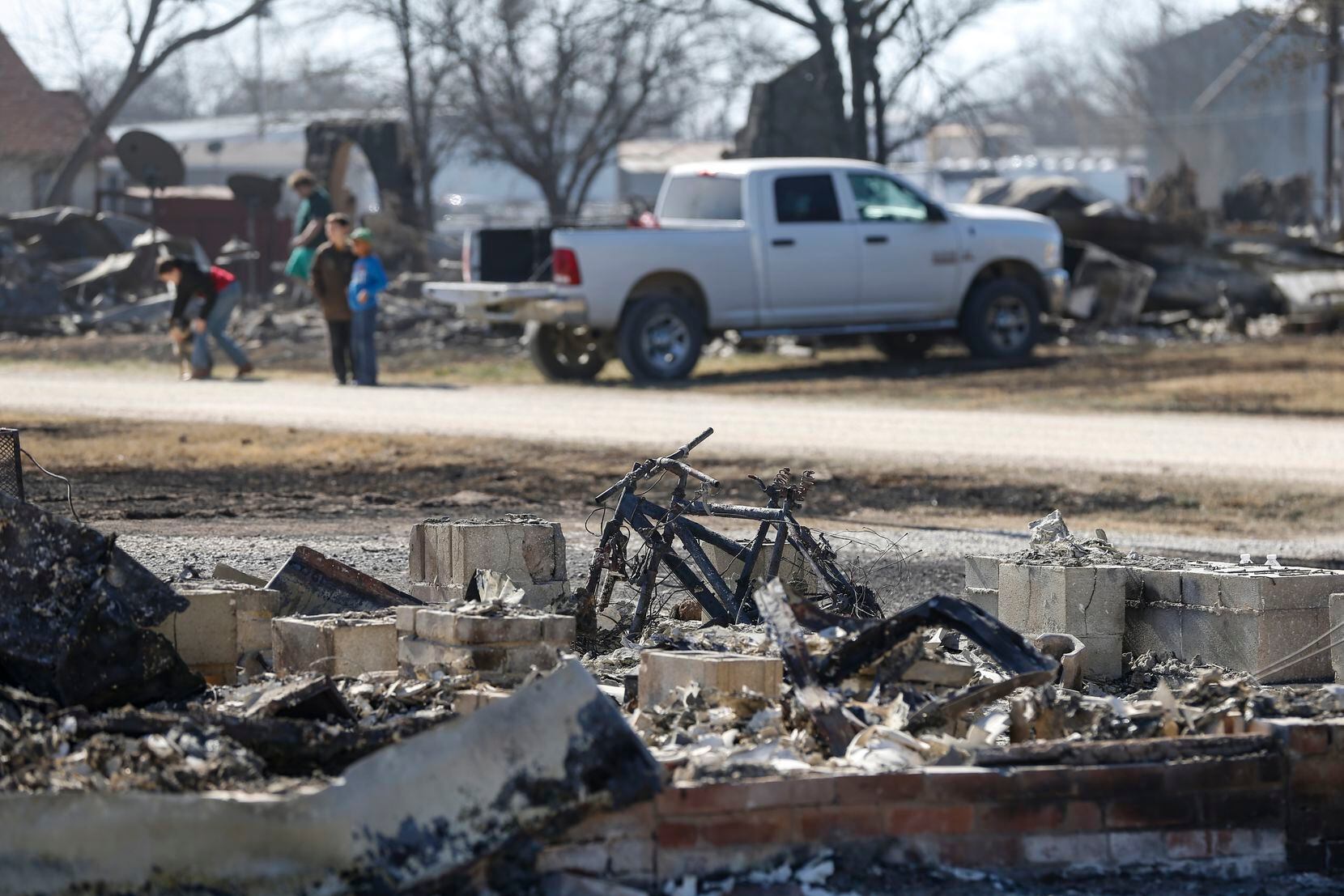 Charred bikes sit among the rubble of a home on Saturday in Carbon.