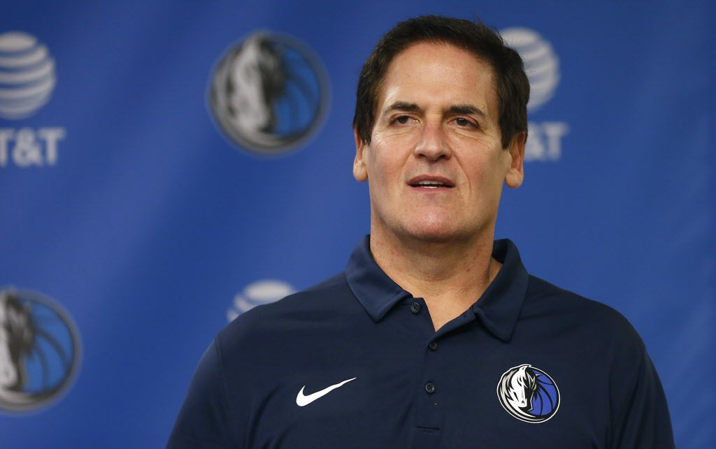 Dallas Mavericks owner Mark Cuban stands on stage before Cynthia Marshall, new interim CEO...