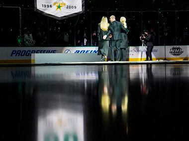 Former Dallas Stars player Sergei Zubov stands with his wife and daughter as a banner...