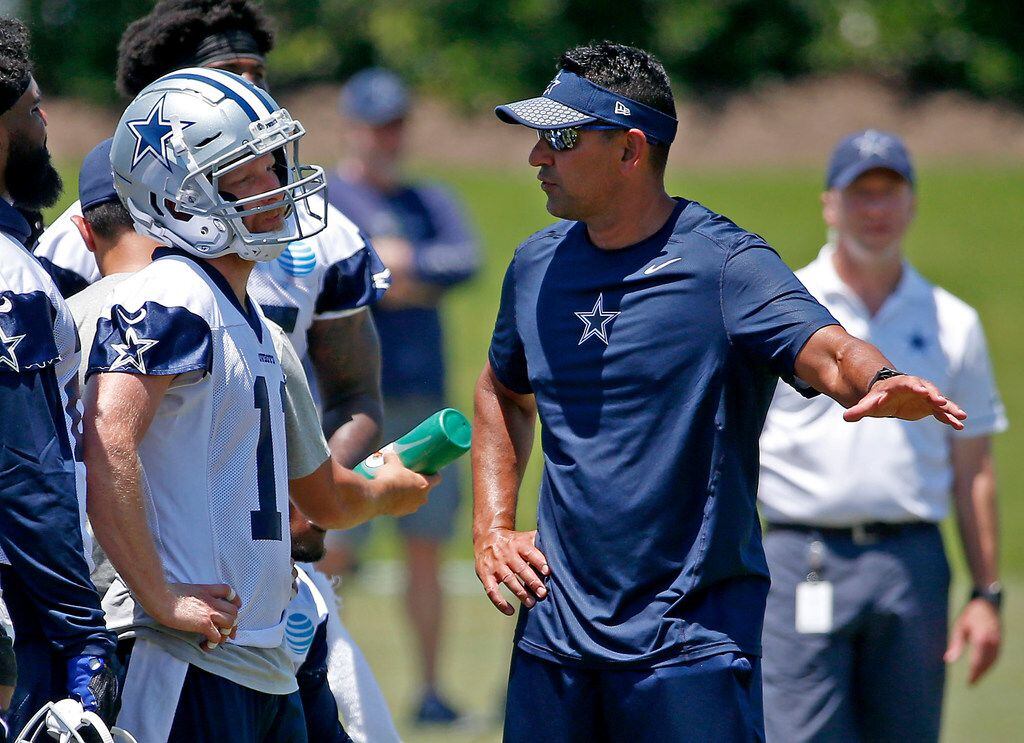 Dallas Cowboys wide receiver coach Sanjay Lal, right, talks with wide receiver Cole Beasley...