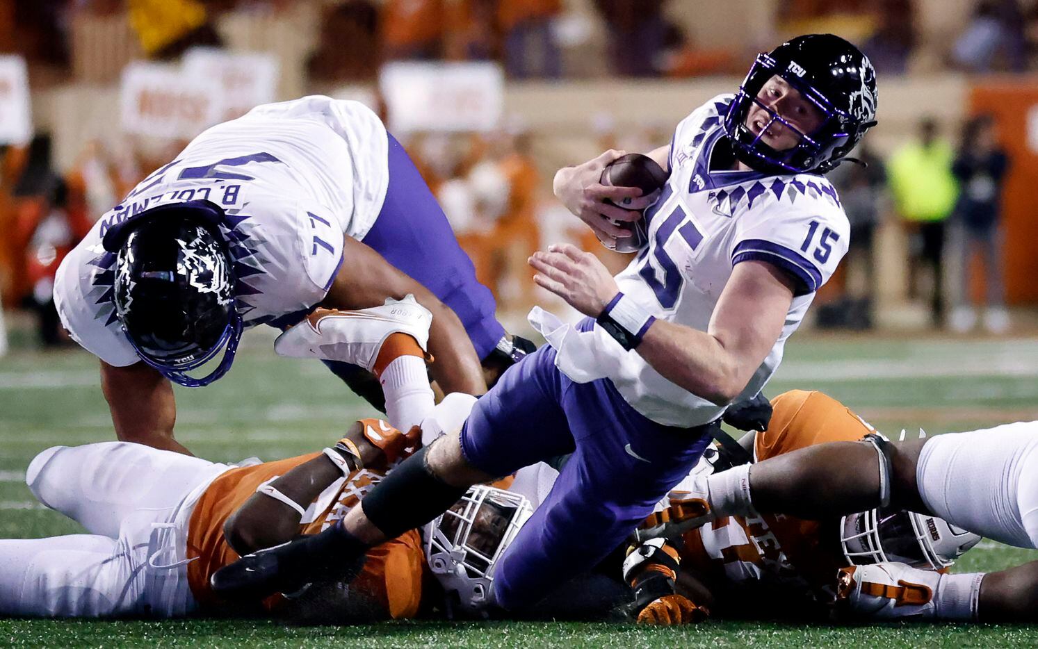TCU Horned Frogs quarterback Max Duggan (15) is tackled in the open field by a pair of Texas...