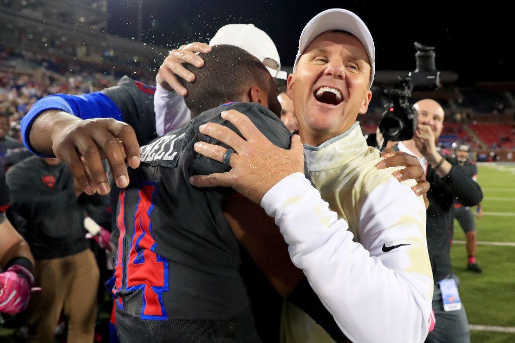 SMU coach Chad Morris celebrates with Jackson Mitchell after the Mustangs beat the Houston...