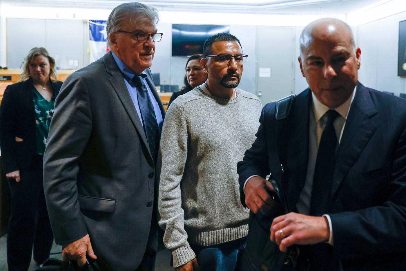 Martin Santillan (center) leaves the courtroom with his defense attorneys Paul Casteleiro...