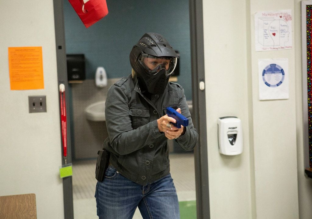 A Texas school employee training to become an armed school marshal steps into a classroom during a practice drill at Windermere Elementary School in Pflugerville, Texas on August 10, 2018. (Thao Nguyen/Special Contributor).