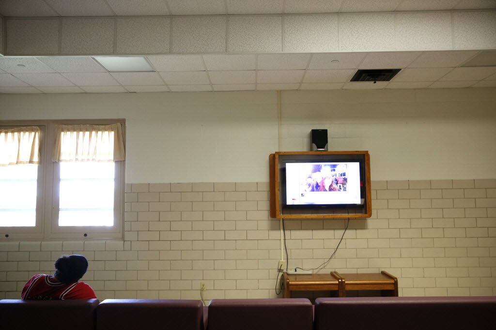 A patient watches TV in the common area of the forensic ward at the Terrell State Hospital...