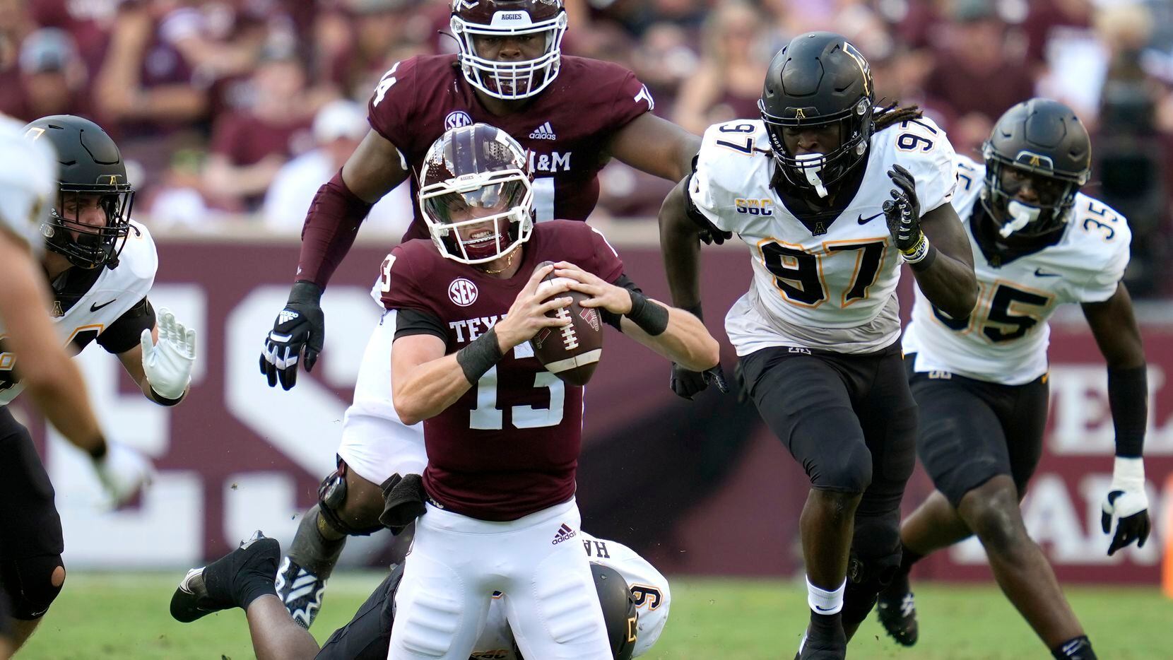 Texas A&M quarterback Haynes King (13) is tackled for no gain by Appalachian State...