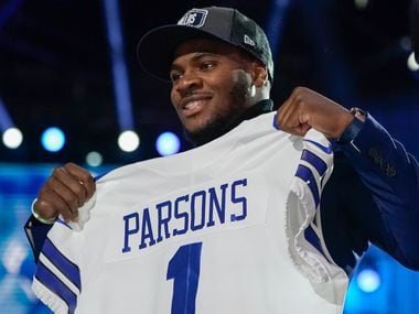 Penn State linebacker Micah Parsons holds a team jersey after the was chosen by the Dallas Cowboys with the 12th pick in the NFL football draft Thursday, April 29, 2021, in Cleveland.