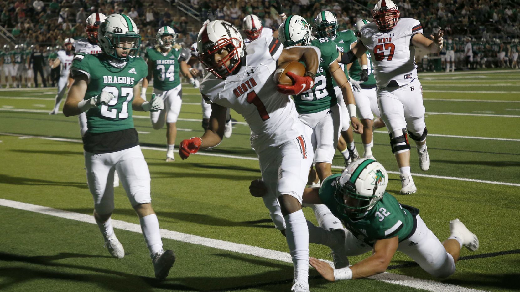 Rockwall Heath player Jay Fair (1) scores a touchdown in front of Southlake’s Mason Grawe...