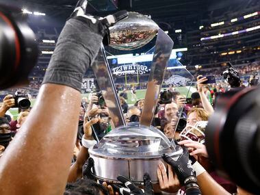 Texas A&M players celebrate after winning against Arkansas at AT&T Stadium in Arlington on...