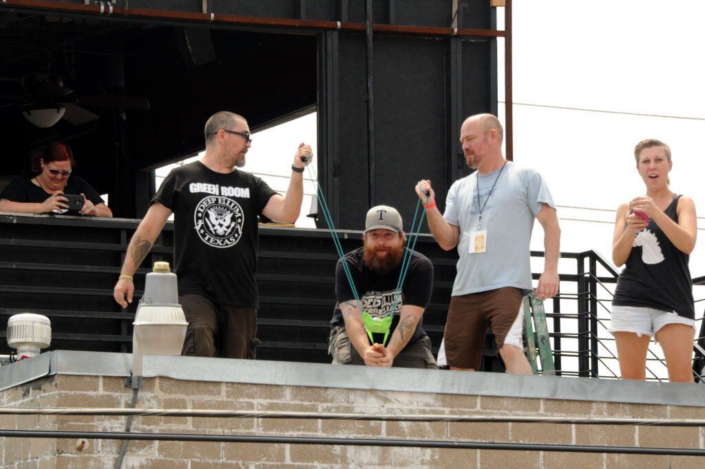 Event organizers launch water balloons into the war from the roof of The Green Room at the...