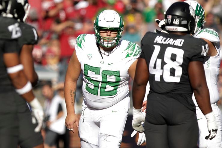 Oregon offensive lineman Jackson Powers-Johnson (58) stands on the field during the second...