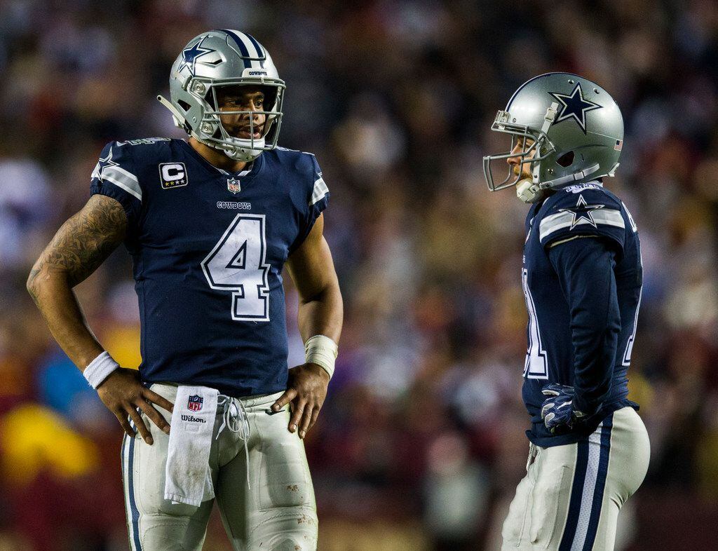 Dallas Cowboys quarterback Dak Prescott (4) talks to wide receiver Cole Beasley (11) during...