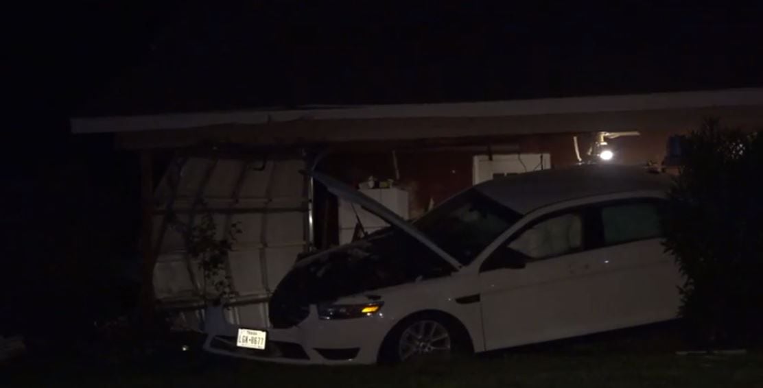 A car that struck a home in Fort Worth lies heavily damaged Thursday night.