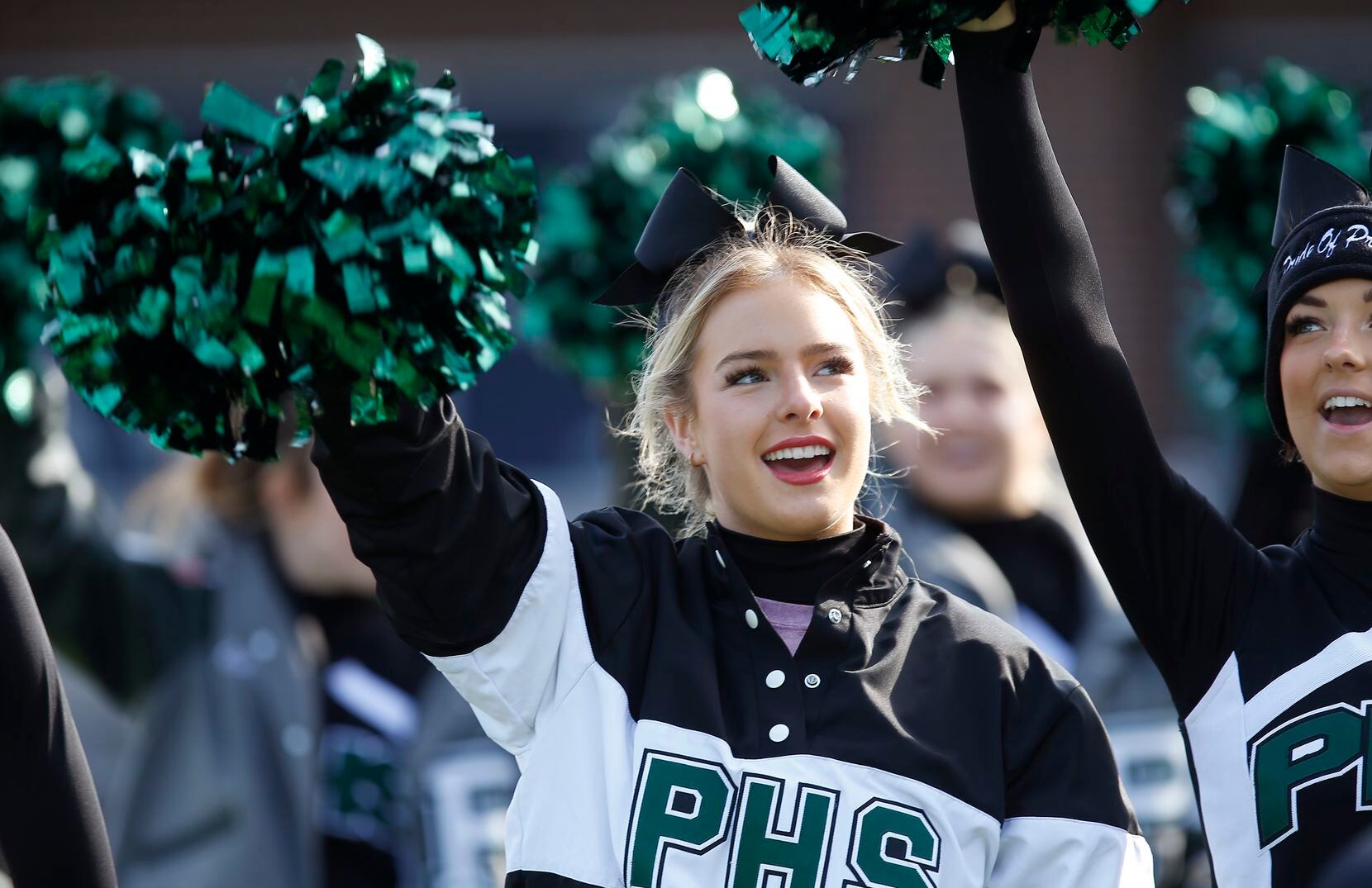 Prosper High School cheerleader Grace Draxler, 17, cheers her team taking the field before...