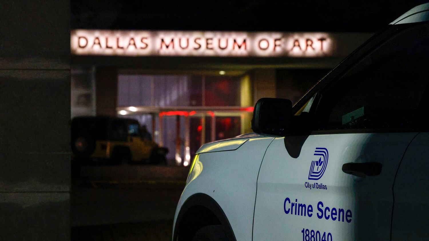 A Dallas police crime scene car sits outside of the Dallas Museum of Art in the early hours...