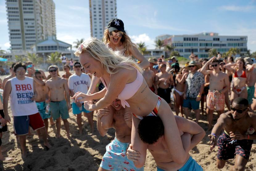 Spring break revelers watched a "chicken fight" at Pompano Beach, Fla., on Tuesday.  Dr....