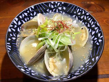 Hamaguri ramen with clams, green onion, mizuna salad, red pepper and sesame seeds at...