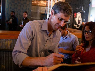Congressman Beto O'Rourke signs a skateboard following a campaign rally  at Lava Cantina in...