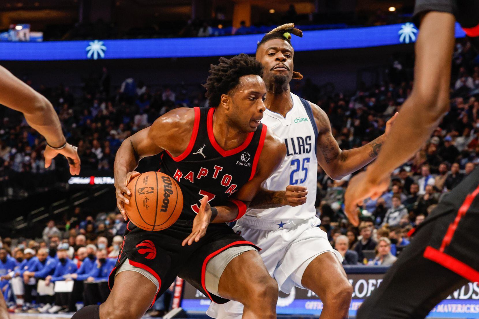 Toronto Raptors OG Anunoby protects the basketball from Dallas Mavericks Reggie Bullock (25)...