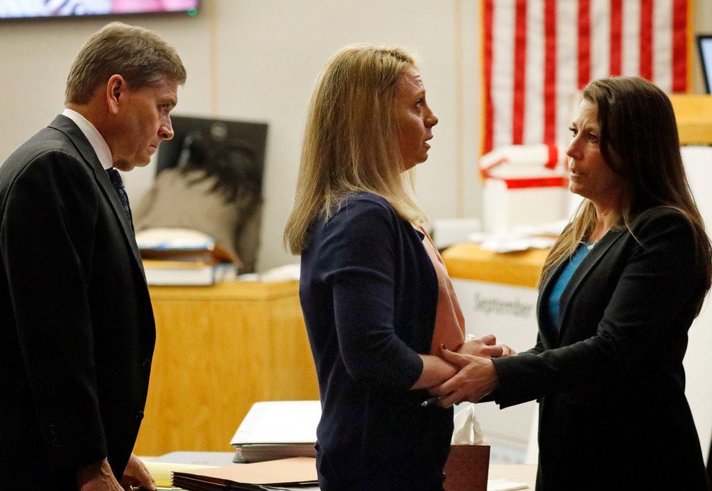 Defense counsel Shelley Shook (right) comforts Amber Guyger during a recess in her murder...